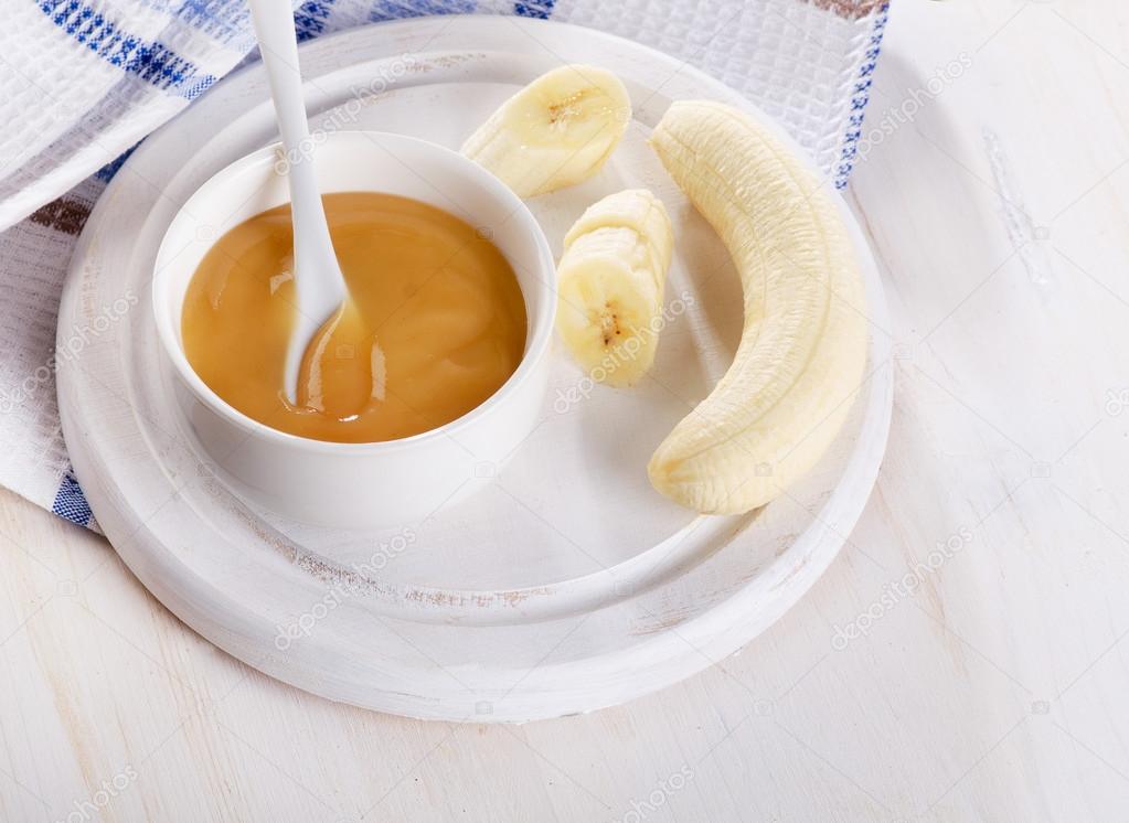 Baby food - bananas puree in bowl.