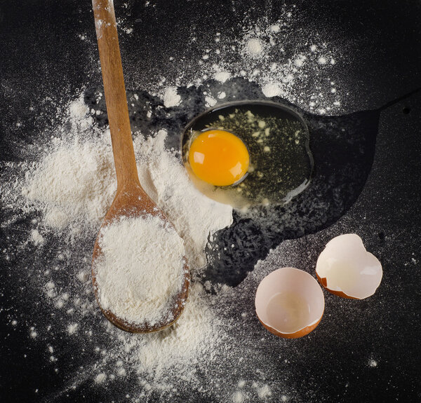 Baking ingredients with egg, eggshell  and flour. 