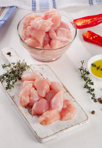 Raw chicken meat with herbs on  a wooden cutting board. — Stock Photo, Image