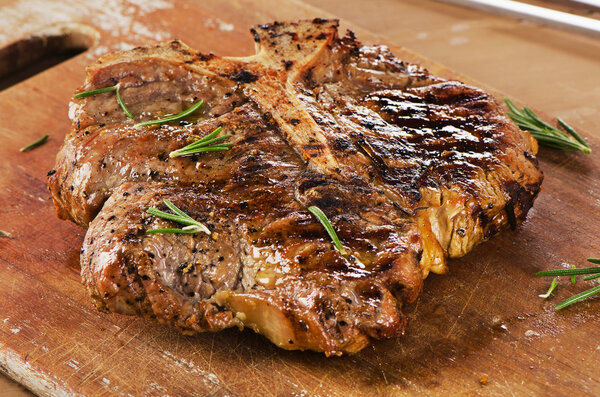 Steak with Herbs on a rustic wooden table