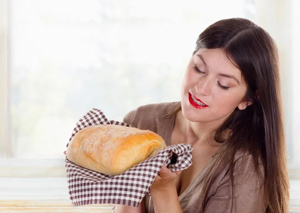 Woman holding  fresh baked bread — Stock Photo, Image