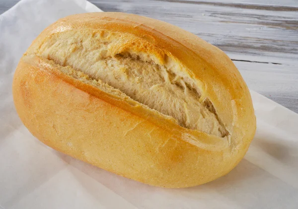 Fresh bread on a wooden board. — Stock Photo, Image