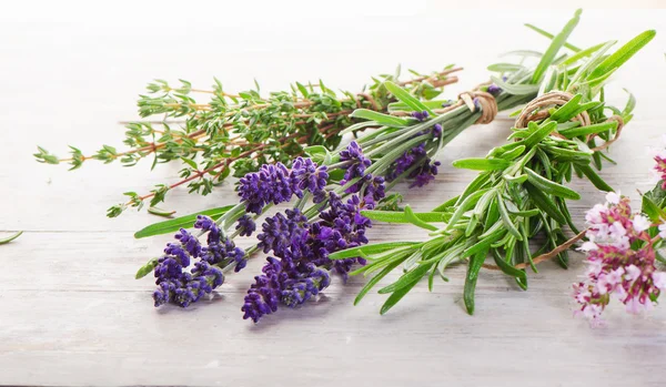 Fresh Herbs on a wooden table.