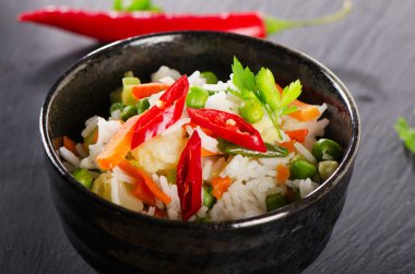 Rice and vegetables on black table
