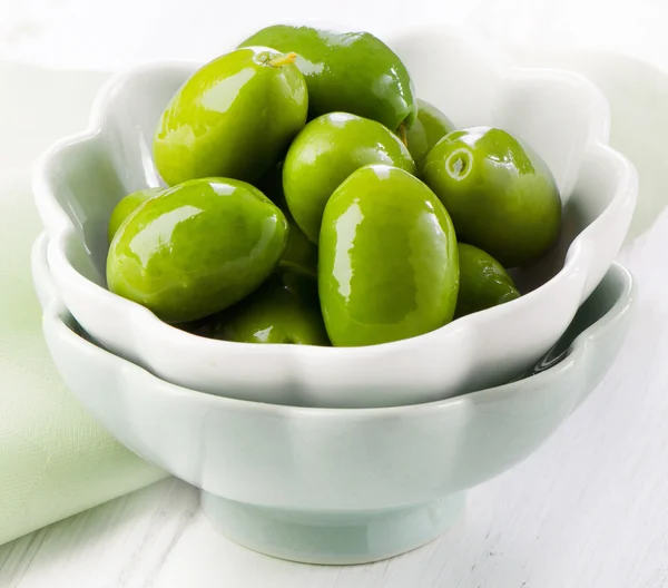 Green olives in white bowl. — Stock Photo, Image