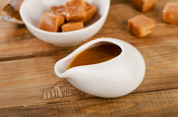 Caramel candies and sauce — Stock Photo, Image