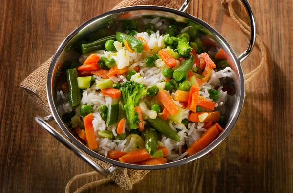 Arroz com legumes na mesa de madeira — Fotografia de Stock