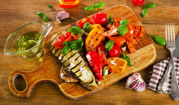Légumes grillés sur une planche de bois . — Photo