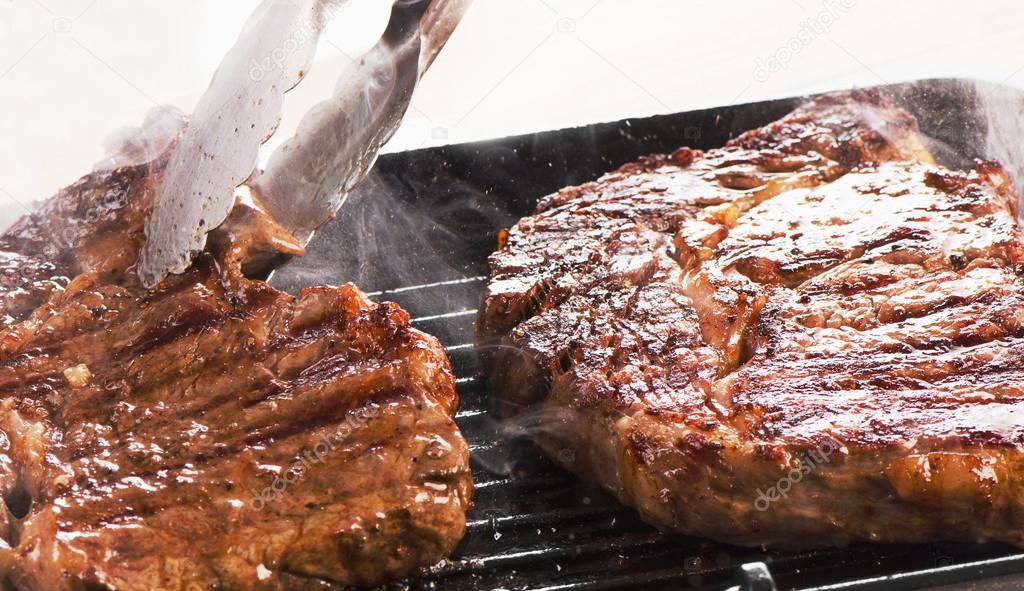 Beef steaks on  grill pan. 