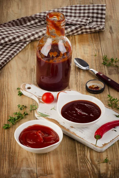 Bowls of tomato and bbq sauce — Stock Photo, Image