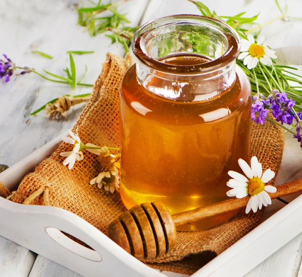 Full honey jar with honey stick — Stock Photo, Image