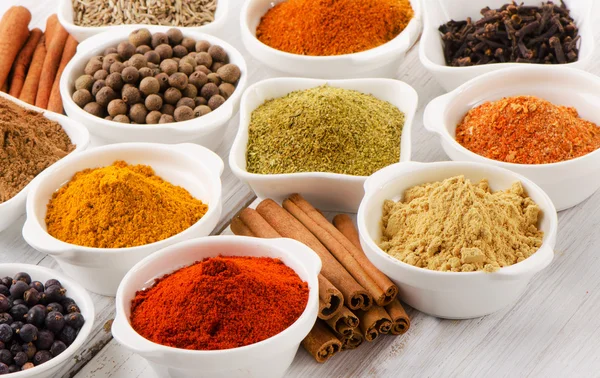 Spices in bowls on table — Stock Photo, Image