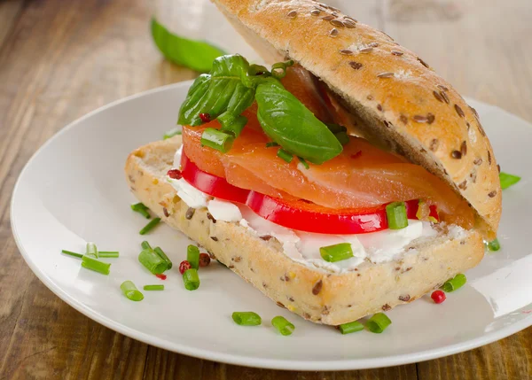 Sandwich with salmon on table. — Stock Photo, Image