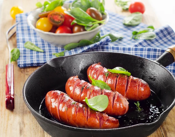 Fried sausages on pan — Stock Photo, Image