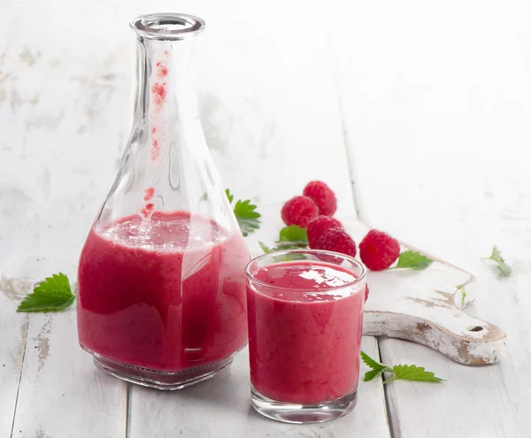 Raspberry smoothie on a white wooden table. — Stock Photo, Image