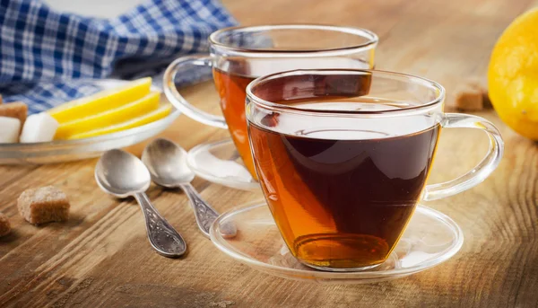 Glass cups of a fresh black tea. — Stock Photo, Image