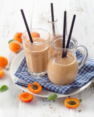 Fresh smoothie in glasses with straws.