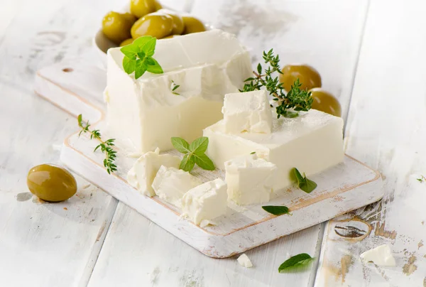 Feta cheese with olives and fresh herbs. — Stock Photo, Image