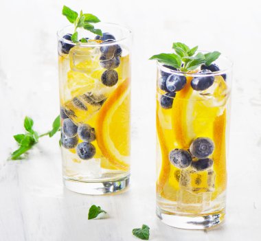 Healthy water with orange and blueberries. clipart