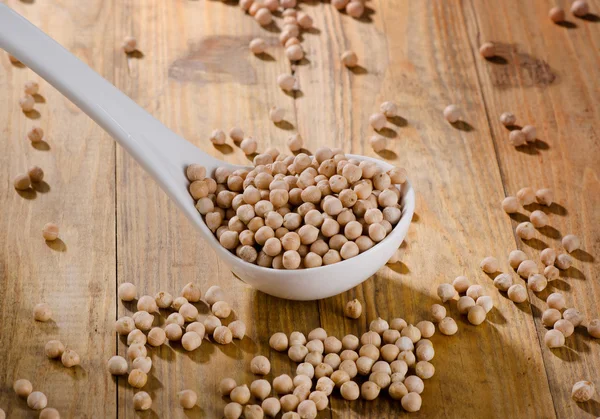 Chickpeas on wooden background. — Stock Photo, Image
