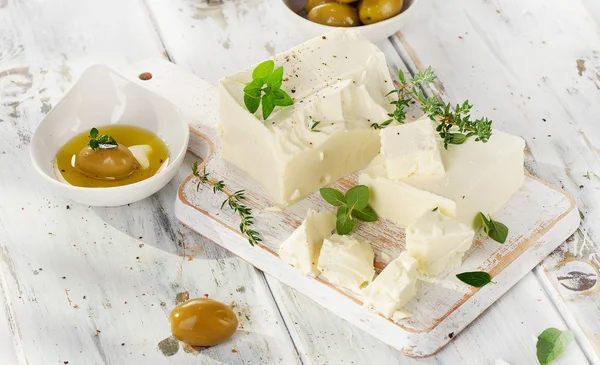 Feta with green olives and herbs. — Stock Photo, Image