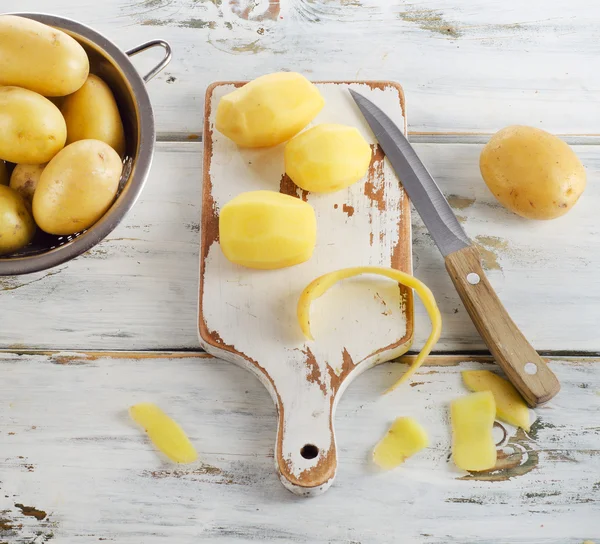 Raw potatoes on wooden table