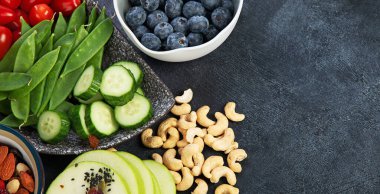 Sağlıklı dengeli diyet kavramı. Zengin lif kaynaklarının seçimi vejetaryen gıdadır. Sebze, meyve, tohum ve fındık. Üst görünüm.