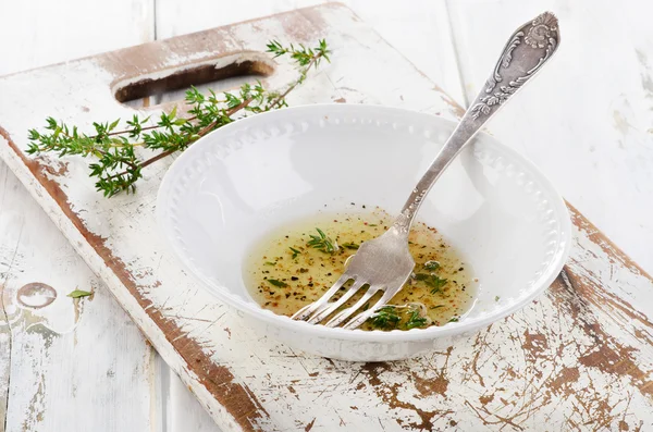 Dressing with thyme in a white bowl. — Stock Photo, Image