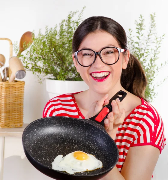 Funny woman holding pan with egg. — Stock Photo, Image