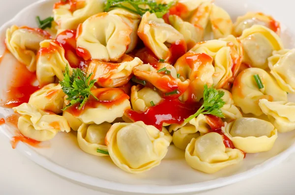 Ravioli pasta with tomato sauce and parsley. — Stock Photo, Image