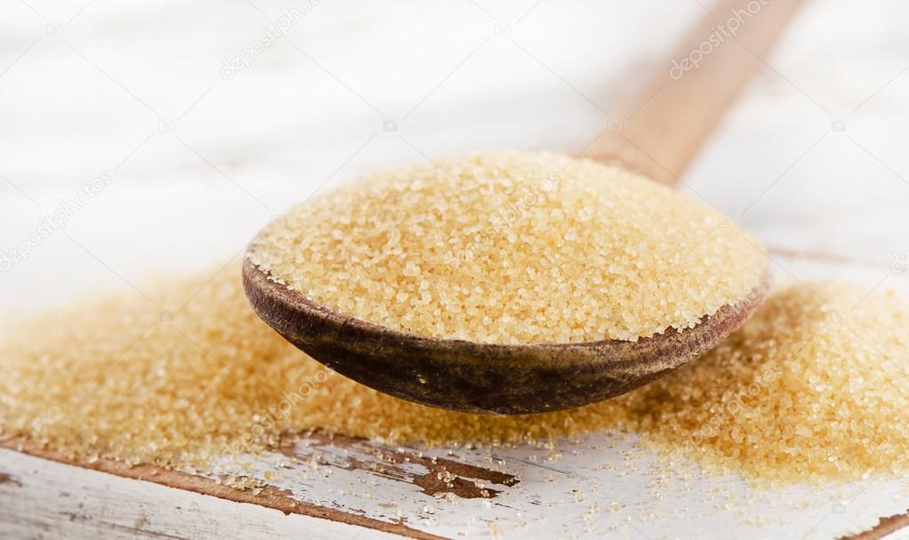 Cane sugar in spoon.