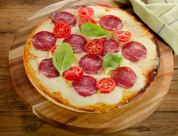 Salami-Pizza auf Holztisch serviert. — Stockfoto