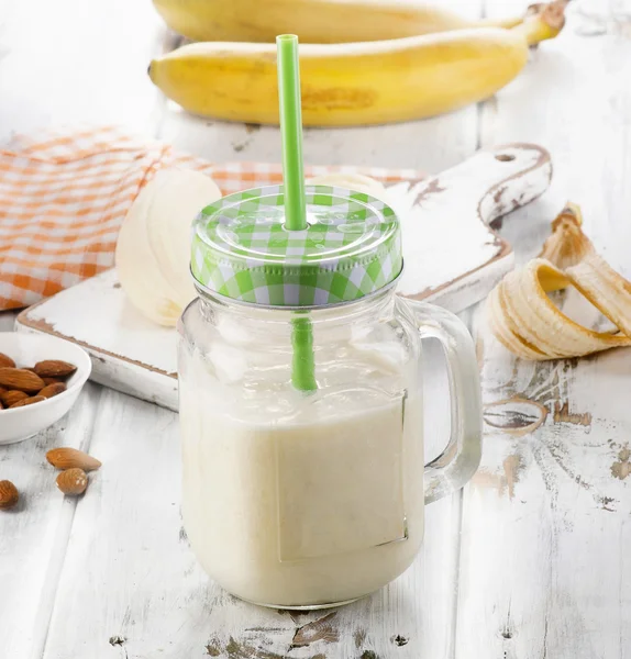 Healthy Banana smoothie on white wooden table. — Stock Photo, Image