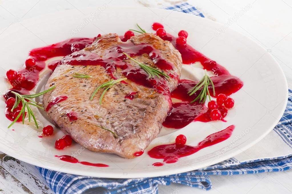 Turkey breast with cranberry sauce.