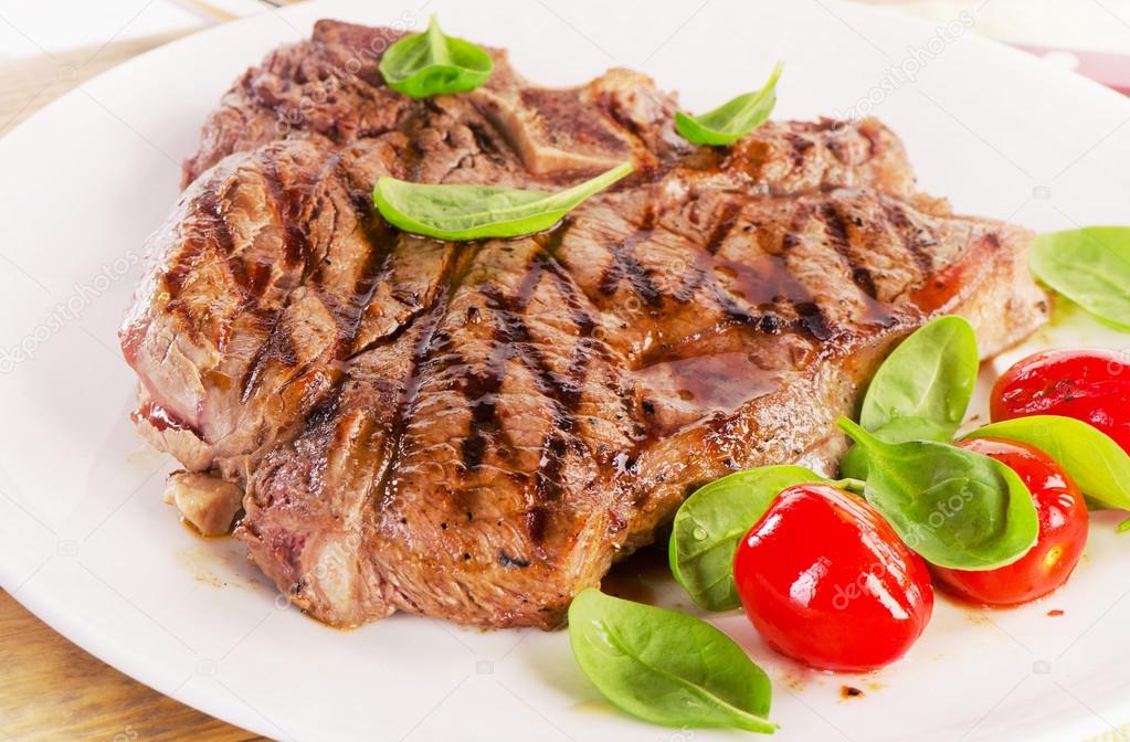 T-bone steak served with herb salad