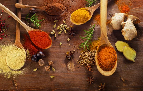 Spices and herbs on wooden background. — Stock Photo, Image