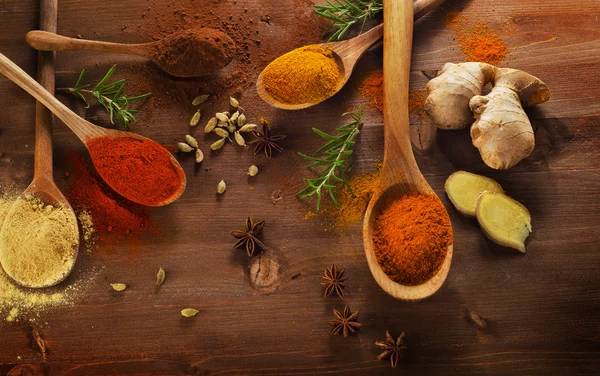 Spices and herbs on a wooden background. — Stock Photo, Image