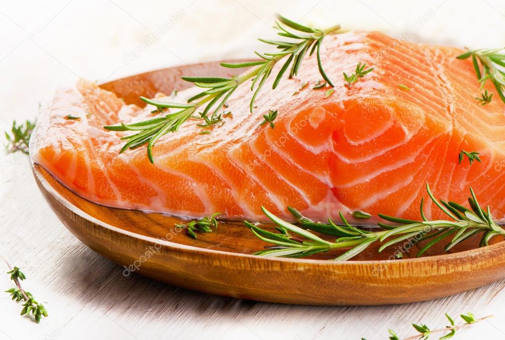 Salmon fillet on wooden background