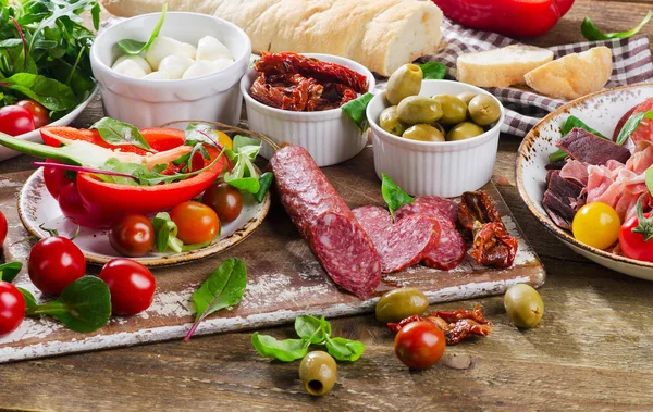 Appetizers on cutting board — Stock Photo, Image