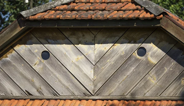 瓷砖屋顶上的圆形窗口 — 图库照片