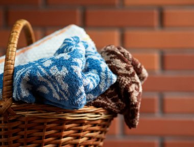 Hasır sepette kırmızı tuğlalı temiz havlular.