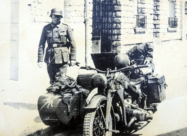 German soldiers posing on a motorcycle