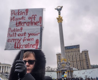 KIEV, UKRAINE - JANUARY 25, 2015: Ukrainian woman holds placard against Russian aggression at Independence Square in Kiev, honored memory of killed victims in Mariupol
