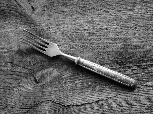 Dining fork on wooden background — Stock Photo, Image