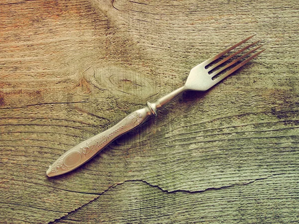 Dining fork on wooden background — Stock Photo, Image