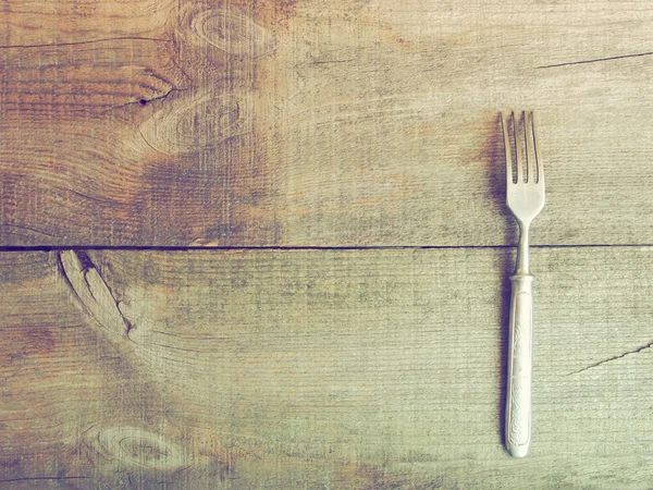 Tenedor de comedor sobre fondo de madera — Foto de Stock