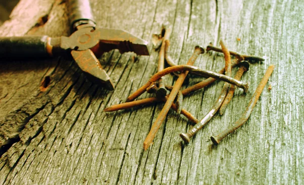 Old rusty pliers and nails — Stock Photo, Image