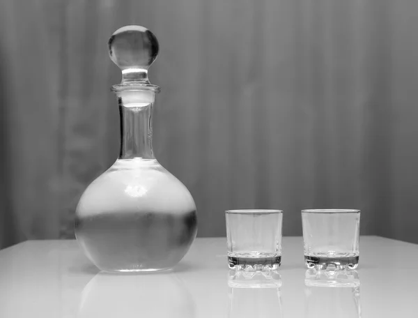 Decanter and two glasses with vodka standing on table — Stock Photo, Image