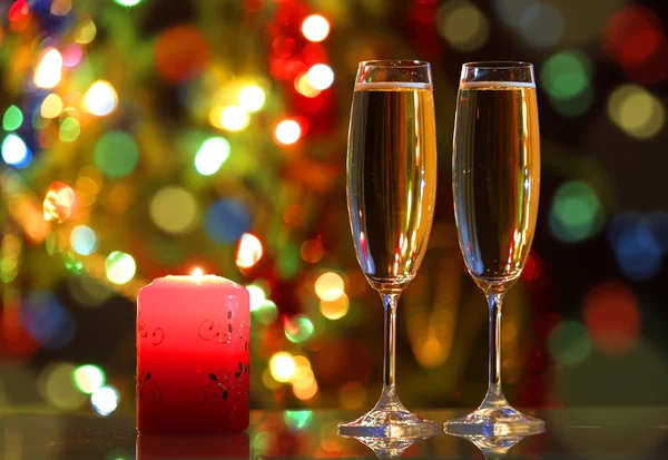 Glasses with champagne and candle — Stock Photo, Image