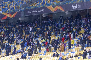 KYIV, UKRAINE - FEBRUARY 18, 2021: Dynamo Kyiv supporters celebrate a goal during the UEFA Europa League game against Club Brugge at NSC Olimpiyskyi stadium in Kyiv, Ukraine
